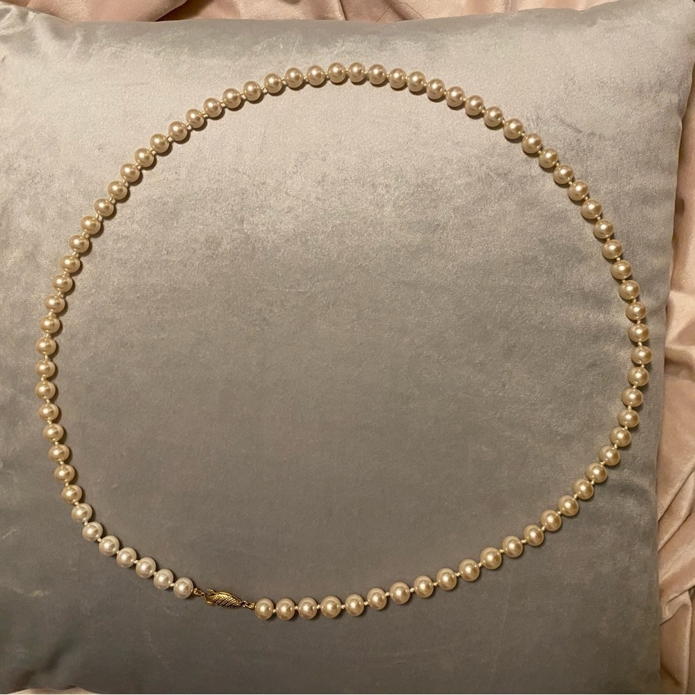 strand of cultured pearls with  filagree clasp.